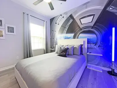a bedroom with a large bed with a painting on the wall at Oakwater Lookout condo in Orlando