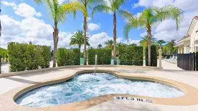a swimming pool with palm trees in the background at Oakwater Lookout condo in Orlando