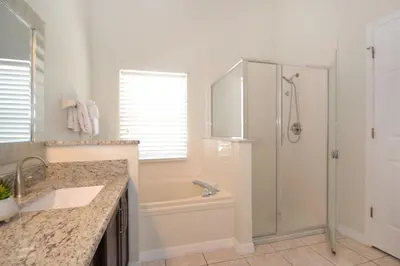 a bathroom with a shower and a sink at Villa Tropics villa in Orlando
