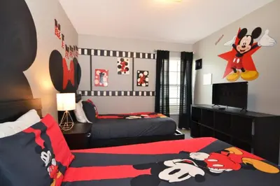 a bedroom with two beds and a mickey mouse bedroom at Villa Tropics villa in Orlando