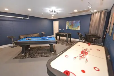 a living room with a pool table and a ping pong table at Villa Tropics villa in Orlando