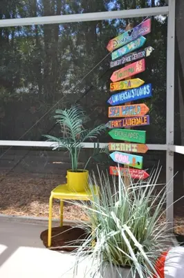 a yellow chair sitting in front of a sign at Villa Tropics villa in Orlando
