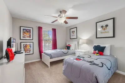 a bedroom with two beds and a ceiling fan at Paradise 4Bd w Private Pool & Waterpark 8951 in Kissimmee