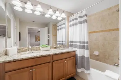 a bathroom with a double sink and a shower at Paradise 4Bd w Private Pool & Waterpark 8951 in Kissimmee