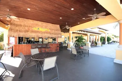 a patio with a bar with a table and chairs at Paradise 4Bd w Private Pool & Waterpark 8951 in Kissimmee