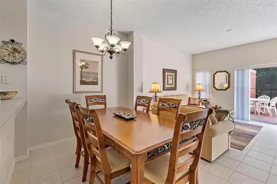 a dining room and living room with a table and chairs at Ormond Retreat townhouse in Kissimmee