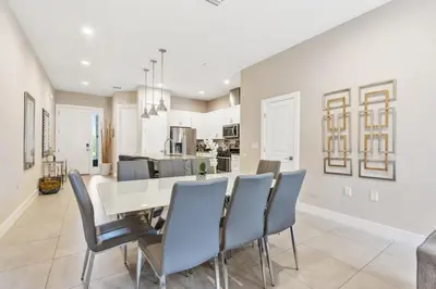 a kitchen and dining room with a table and chairs at Sunrise Shores townhouse in Orlando