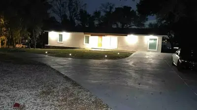 a house with a car parked in a driveway at night at Casa 5Q c/ Piscina e Vista Lago — 3min Universal in Orlando
