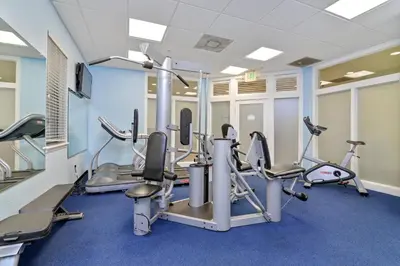 a gym with treadmills and elliptical machines at Serene Gem, close to Disney- HEATEDsaltwaterPOOL in Kissimmee