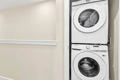a washer and a washing machine in a room at Unplug in your private oasis-NEW corner Home Pool in Orlando