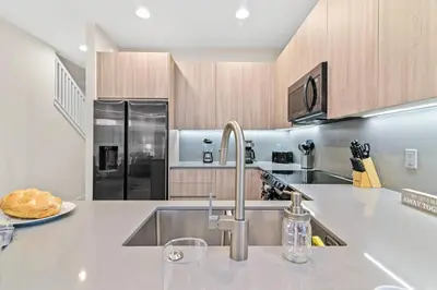 a kitchen with a sink and a counter top at Unplug in your private oasis-NEW corner Home Pool in Orlando