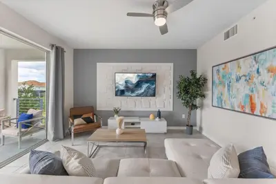 a living room with a white couch and a ceiling fan at 3121-207 Resort Lake View Disney Universal Orlando in Kissimmee