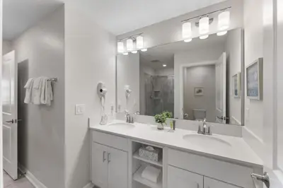a bathroom with two sinks and a large mirror at 3121-207 Resort Lake View Disney Universal Orlando in Kissimmee
