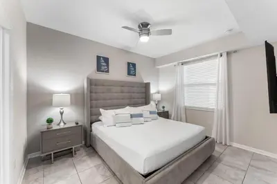 a bedroom with a bed and a ceiling fan at 3121-207 Resort Lake View Disney Universal Orlando in Kissimmee