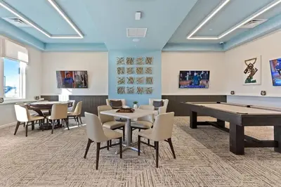 a gaming room with ping pong tables and chairs at Casa 4Q c/ Piscina Priv. no Storey Lake in Kissimmee
