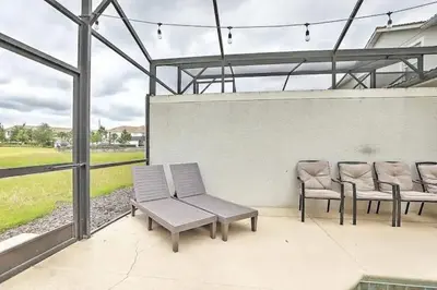 a group of chairs and benches on a patio at Let's Glo Now Adventure Cove Villa townhouse in Kissimmee