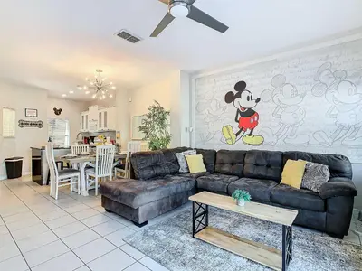 a living room with a couch and a dining room at Cozy Townhouse with Private Pool in Kissimmee in Kissimmee