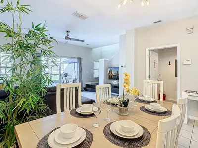 a dining room with a table and chairs in a room at Cozy Townhouse with Private Pool in Kissimmee in Kissimmee