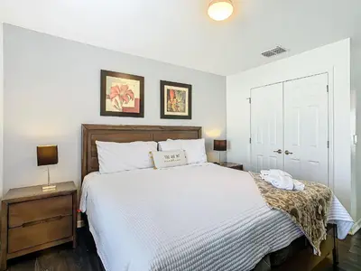 a bedroom with a large white bed with two night stands at Cozy Townhouse with Private Pool in Kissimmee in Kissimmee