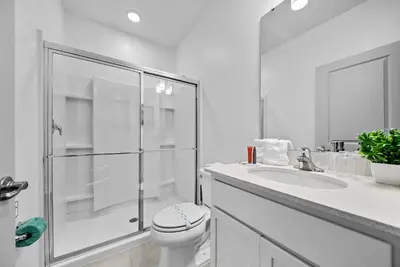 a bathroom with a shower and a toilet and a sink at Brand NEW 5 BRD At Paradiso Grande Near Sea World in Orlando