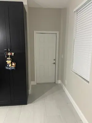 a room with a black door and a white floor at Orlando 4 bedroom built in 2021 in Orlando