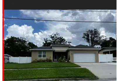 a house with a white fence in a yard at Orlando 4 bedroom built in 2021 in Orlando