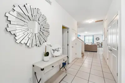 a living room with a large clock on the wall at Lake Side View Private Pool Home In Resort! villa in Kissimmee