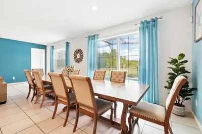 a dining room with a table and chairs at Lake Side View Private Pool Home In Resort! villa in Kissimmee