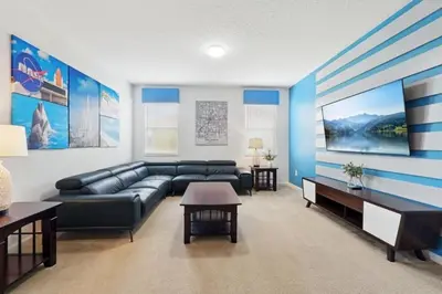 a living room with a couch and a table at Lake Side View Private Pool Home In Resort! villa in Kissimmee