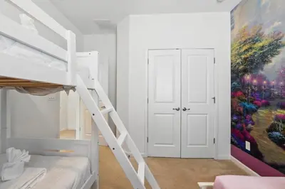 a bedroom with a bunk bed and a painting on the wall at Lake Side View Private Pool Home In Resort! villa in Kissimmee