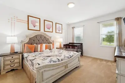 a bedroom with a large bed and a crib at Lake Side View Private Pool Home In Resort! villa in Kissimmee