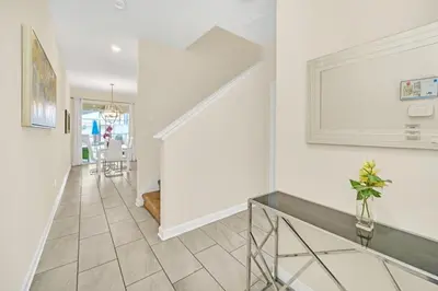 a hallway with a staircase and a vase of flowers at Beautiful Paradise Palms Retreat townhouse in Kissimmee