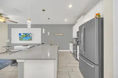 a kitchen with a stainless steel refrigerator in it at Beautiful Paradise Palms Retreat townhouse in Kissimmee