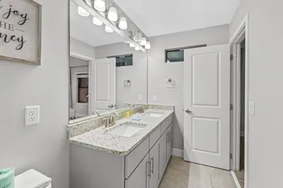 a bathroom with two sinks and a large mirror at Gated community 4BD townhouse next to Disney in Kissimmee