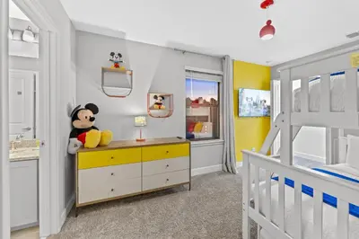 a childs bedroom with yellow and white walls at Gated community 4BD townhouse next to Disney in Kissimmee