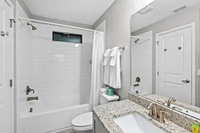 a white bathroom with a sink and a toilet at Gated community 4BD townhouse next to Disney in Kissimmee