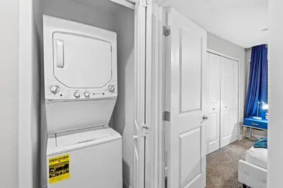 a kitchen with a washer and dryer in a room at Gated community 4BD townhouse next to Disney in Kissimmee