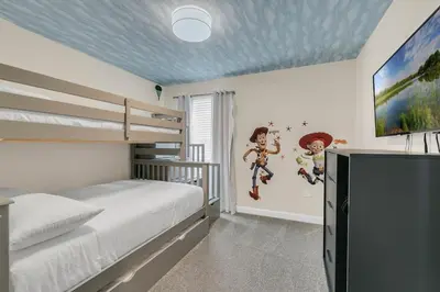 a bedroom with a bed and a tv in it at 6 Bedrooms 6 Bathrooms Storey Lake home in Orlando