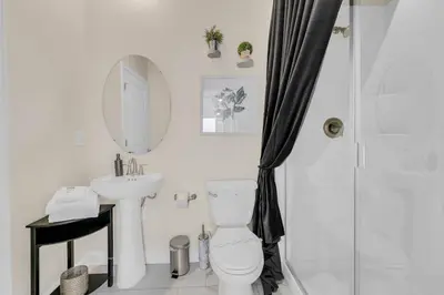 a bathroom with a toilet and a sink and a shower at 6 Bedrooms 6 Bathrooms Storey Lake home in Orlando
