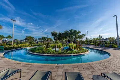 a pool at a resort with palm trees at 6 Bedrooms 6 Bathrooms Storey Lake home in Orlando