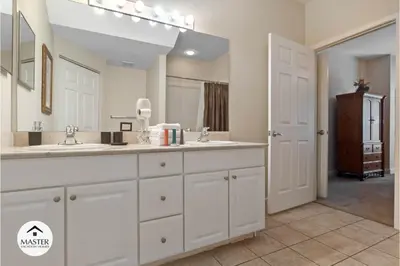 a bathroom with two sinks and a large mirror at 3 Bedrooms 2 Bathrooms Lucaya Village townhouse in Kissimmee