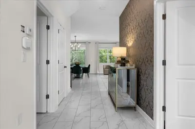 a hallway with a table and a dining room at 7 Bedroom 6 Bathrooms Storey Lake Resort home in Kissimmee