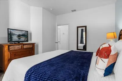 a bedroom with a bed and a television in it at 3 Bedrooms 2 Bathrooms Lucaya Village townhouse in Kissimmee