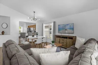 a living room with a couch and a table at 3 Bedrooms 2 Bathrooms Lake Berkley home in Kissimmee