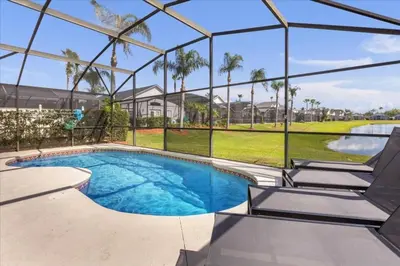 a swimming pool in a building with a view of a golf course at 3 Bedrooms 2 Bathrooms Lake Berkley home in Kissimmee