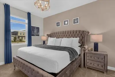 a bedroom with a large bed and a window at 8 Bedroom & Theme Rooms For Kids In Storey Lake home in Kissimmee