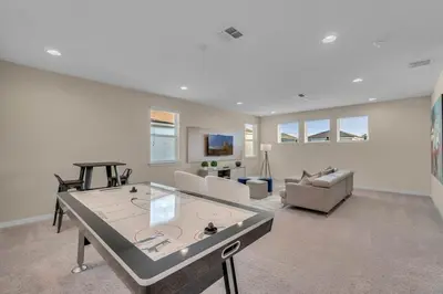 a living room with a couch and a table at 5 Bedrooms 5,5 Bathrooms Solara home in Orlando