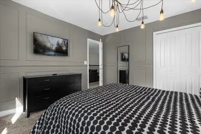 a bedroom with a bed and a tv on the wall at 9 Bed Storey Lake Star Wars Dream Home home in Kissimmee