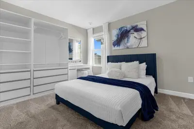 a bedroom with a blue and white bed and shelves at 9 Bed Storey Lake Star Wars Dream Home home in Kissimmee