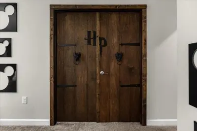 a wooden door in the middle of a room at 9 Bed Storey Lake Star Wars Dream Home home in Kissimmee